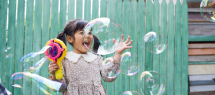 Child playing in bubbles